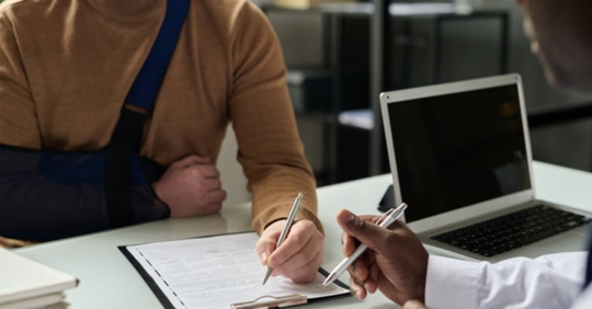 man in arm band talking to personal injury attorney
